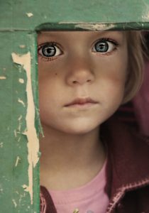 Sad little girl with blue eyes